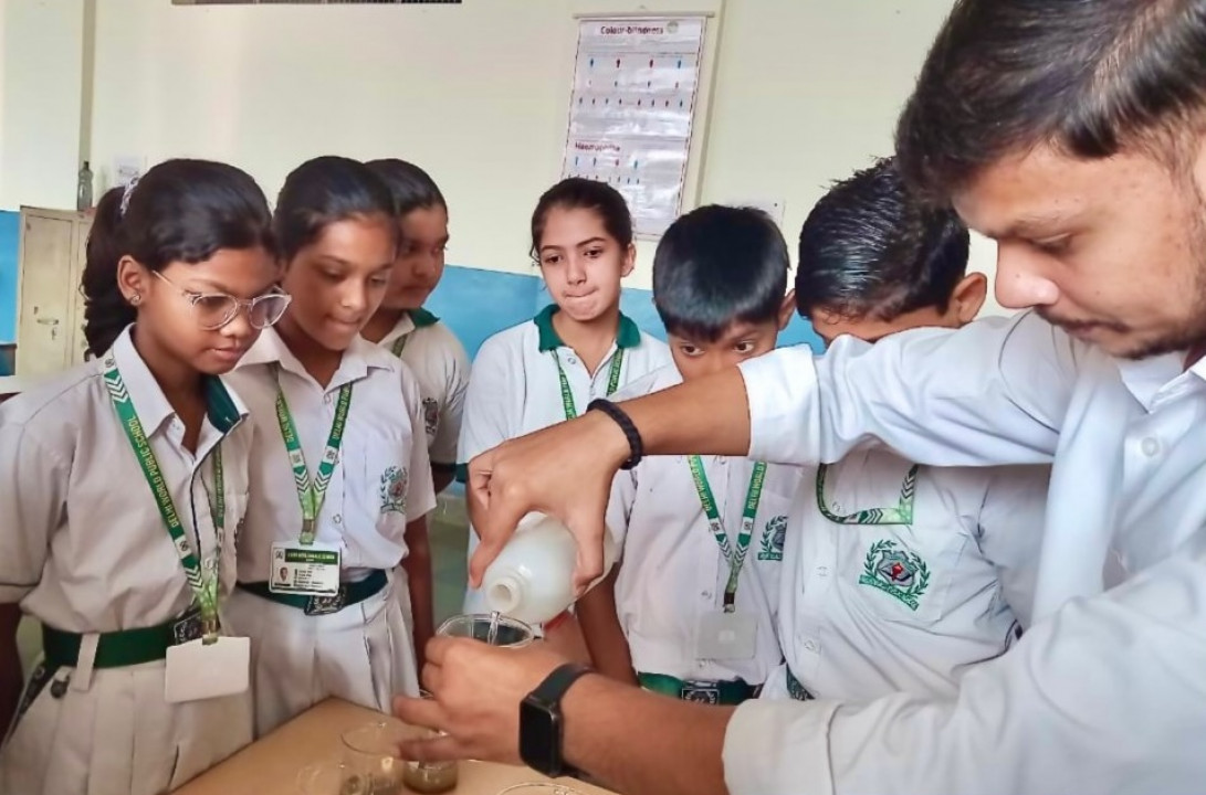 DWPS students conduct a hands-on experiment to measure the water percolation rate in soil